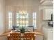 Cozy breakfast nook with a bay window, breakfast table, and a view of the backyard at 5949 225Th E St, Bradenton, FL 34211