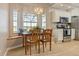 Bright breakfast nook with a large window, custom bench, and a wooden table and chairs at 5949 225Th E St, Bradenton, FL 34211