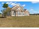 Side view of the charming brown home featuring white windows and a well-maintained lawn at 5949 225Th E St, Bradenton, FL 34211