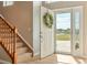 Bright foyer with hardwood floors and a staircase leading to the second floor at 5949 225Th E St, Bradenton, FL 34211