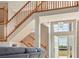 Foyer showcasing hardwood staircase and entry door with natural lighting at 5949 225Th E St, Bradenton, FL 34211