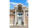 Close up of the home's front entrance with stone accents and a charming wreath at 5949 225Th E St, Bradenton, FL 34211