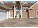 Charming front entrance features a decorative wreath and stone accents at 5949 225Th E St, Bradenton, FL 34211
