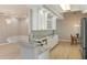 Modern kitchen with marble countertops, stainless steel appliances, and white cabinets at 5949 225Th E St, Bradenton, FL 34211
