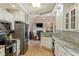 Well-lit kitchen with granite countertops, stainless steel appliances and view to living room at 5949 225Th E St, Bradenton, FL 34211