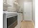 Well-equipped laundry room featuring a modern washer and dryer, sink and storage at 5949 225Th E St, Bradenton, FL 34211