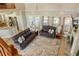 Spacious living room with high ceilings, a fireplace, and views of the pool through large windows at 5949 225Th E St, Bradenton, FL 34211