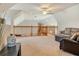 Bright open loft with natural lighting, ceiling fan, and wood railing at 5949 225Th E St, Bradenton, FL 34211