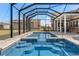 Enclosed pool area with blue water, steps, and patio overlooking outbuildings and a large open lawn at 5949 225Th E St, Bradenton, FL 34211