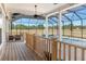 A covered outdoor pool area featuring a hot tub, grill, and seating area at 5949 225Th E St, Bradenton, FL 34211