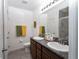 Bright bathroom with double sink vanity, granite countertops, and tiled shower at 6473 Baytown Dr, Sarasota, FL 34240