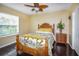 Bedroom with a tropical-themed bed set, wood floors, and natural light at 6473 Baytown Dr, Sarasota, FL 34240