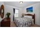 Bedroom features wood furniture, neutral walls, and natural light at 6473 Baytown Dr, Sarasota, FL 34240