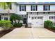 A lovely townhouse with a one-car garage, complemented by lush, well-maintained landscaping at 6473 Baytown Dr, Sarasota, FL 34240