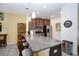 Open-concept kitchen featuring a large island with granite countertops, pendant lights, and barstool seating at 6473 Baytown Dr, Sarasota, FL 34240