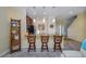 Stylish kitchen with granite countertop island with bar stools, open to the staircase and living room at 6473 Baytown Dr, Sarasota, FL 34240