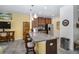 Contemporary kitchen island with granite countertops, dark cabinetry, pendant lighting, and seating at 6473 Baytown Dr, Sarasota, FL 34240