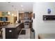 Modern kitchen featuring dark wood cabinets, stainless steel appliances, and granite countertops at 6473 Baytown Dr, Sarasota, FL 34240