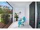 Screened-in patio area with a blue chair, plant, and views of the backyard at 6473 Baytown Dr, Sarasota, FL 34240