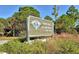 Sign for Oscar Scherer State Park, surrounded by native plants and trees at 767 Pine Run Dr, Osprey, FL 34229