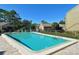 Community swimming pool with clear water, surrounded by landscaping and a paved deck, perfect for summer relaxation at 767 Pine Run Dr, Osprey, FL 34229