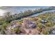 Aerial view showcases a property in progress on the water, emphasizing its prime location and potential for customization at 8555 Heron Lagoon Cir, Sarasota, FL 34242