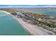 Expansive aerial view showcasing beachfront living along the coast and waterway at 8555 Heron Lagoon Cir, Sarasota, FL 34242