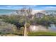 Aerial view showcases a waterfront property with a wooden walkway, lush greenery, and scenic ocean views at 8555 Heron Lagoon Cir, Sarasota, FL 34242