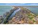 Panoramic aerial view showcases waterfront homes and lush landscaping, highlighting the community's desirable coastal setting at 8555 Heron Lagoon Cir, Sarasota, FL 34242