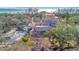 Aerial view of a home, highlighting landscaping, mature trees, and proximity to a waterfront at 8555 Heron Lagoon Cir, Sarasota, FL 34242
