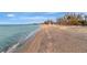 Expansive sandy beach with gentle waves, perfect for relaxation and recreation at 8555 Heron Lagoon Cir, Sarasota, FL 34242