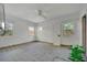 Bright bedroom with three windows and a ceiling fan, ready for renovation and personal touches at 8555 Heron Lagoon Cir, Sarasota, FL 34242