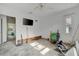 Renovated bedroom featuring white walls, ceiling fan, natural light, and ample space at 8555 Heron Lagoon Cir, Sarasota, FL 34242