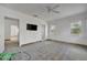 Clean and bright renovated room featuring white walls, a ceiling fan, and natural light from multiple windows at 8555 Heron Lagoon Cir, Sarasota, FL 34242