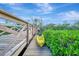 Wooden dock featuring a yellow kayak, overlooking tranquil waters at 8555 Heron Lagoon Cir, Sarasota, FL 34242