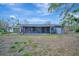 Exterior view of the house featuring a covered porch, neutral color palette and a well-maintained yard at 8555 Heron Lagoon Cir, Sarasota, FL 34242