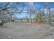 Charming single-story home with mature trees in the front yard at 8555 Heron Lagoon Cir, Sarasota, FL 34242