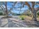 Picturesque property surrounded by mature trees, offering a tranquil setting and privacy at 8555 Heron Lagoon Cir, Sarasota, FL 34242