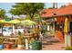 Outdoor patio with wooden tables, umbrellas, and festive decorations at 8555 Heron Lagoon Cir, Sarasota, FL 34242