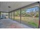 Spacious screened porch with tile flooring offers seamless indoor-outdoor living and beautiful backyard views at 8555 Heron Lagoon Cir, Sarasota, FL 34242