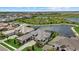 Aerial view of an upscale neighborhood featuring homes with pools and lake views at 9241 Starry Night Ave, Sarasota, FL 34241