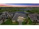 Stunning aerial view of a luxury home with serene lakefront setting and lush landscaping at 9241 Starry Night Ave, Sarasota, FL 34241