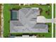 Aerial view showcases roof and rear of home with pool in landscaped yard at 9241 Starry Night Ave, Sarasota, FL 34241