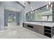 Bright bathroom featuring a soaking tub, an oversized mirror, and double vanity at 9241 Starry Night Ave, Sarasota, FL 34241