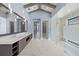 Bright bathroom featuring a soaking tub, oversized mirror, and glass shower at 9241 Starry Night Ave, Sarasota, FL 34241