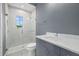 Modern bathroom showcasing a glass-enclosed shower and vanity with a quartz countertop at 9241 Starry Night Ave, Sarasota, FL 34241