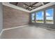 Bedroom with three large windows and a wooden accent wall at 9241 Starry Night Ave, Sarasota, FL 34241