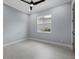 Simple bedroom with light blue walls, tile flooring, a ceiling fan and a window at 9241 Starry Night Ave, Sarasota, FL 34241