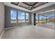 Bedroom featuring water views and large sliding doors to a screened pool at 9241 Starry Night Ave, Sarasota, FL 34241