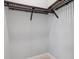 Empty walk-in closet with upper shelving and hanging rods, ready for organization at 9241 Starry Night Ave, Sarasota, FL 34241